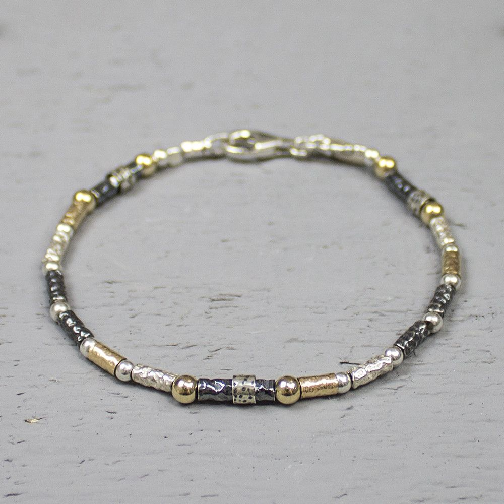 Armband gemaakt van 925 sterling zilver, geoxideerd zilver en goldfilled. Deze armband is een uitbreiding op de 17710, heeft afwisselend de eerder genoemde metaalsoorten en is bewerkt met een lichte hamerslag. Over een aantal schakels zit een zi